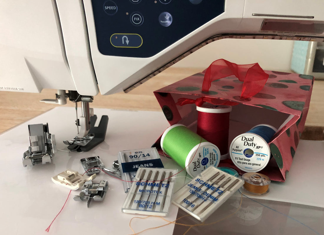 Sewing machine presser feet, needles, thread, small bag with buttons.